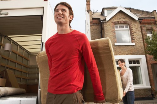 Moving team handling boxes and furniture in a flat near Honor Oak Park