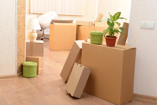 Local moving team handling furniture on a Honor Oak street