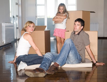 Packed boxes and furniture being loaded into a removal truck